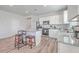 Eat-in kitchen with island, white cabinets, granite countertops, and hardwood floors at 286 W Bradford Pointe Dr, Summerville, SC 29486