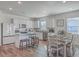 Open concept kitchen with island, dining area, and hardwood floors at 286 W Bradford Pointe Dr, Summerville, SC 29486