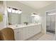 Bathroom with double sinks and a walk-in shower at 309 Palmetto Blvd, Edisto Island, SC 29438
