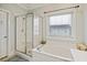 Bathroom with shower and a soaking tub at 309 Palmetto Blvd, Edisto Island, SC 29438
