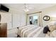 Bedroom with striped bedding and sliding glass door to balcony at 309 Palmetto Blvd, Edisto Island, SC 29438