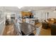 Long dark wood table with white chairs, seats 10 at 309 Palmetto Blvd, Edisto Island, SC 29438