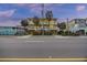 Two-story beach house with lighted balconies, palm trees, and parking at 309 Palmetto Blvd, Edisto Island, SC 29438