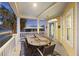 Inviting porch with a large wooden dining table at 309 Palmetto Blvd, Edisto Island, SC 29438