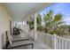 Spacious porch with rocking chairs and palm trees at 309 Palmetto Blvd, Edisto Island, SC 29438