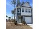 Two-story house with gray siding, white accents, and a two-car garage at 413 Trotters Ln, Moncks Corner, SC 29461