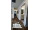Light-filled hallway with wood-look flooring and artwork at 413 Trotters Ln, Moncks Corner, SC 29461