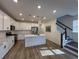 Modern kitchen with white cabinets, quartz countertops, and an island at 413 Trotters Ln, Moncks Corner, SC 29461