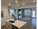 Open concept kitchen with island and stainless steel appliances, overlooking living room at 413 Trotters Ln, Moncks Corner, SC 29461