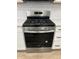 Stainless steel gas stove with multiple burners, digital screen, and knobs on white cabinets in kitchen at 413 Trotters Ln, Moncks Corner, SC 29461