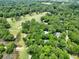 Aerial view of golf course community with houses nestled among lush trees at 5105 St George Ln, Hollywood, SC 29449