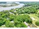 Aerial view showcasing waterfront property, golf course, and houses at 5105 St George Ln, Hollywood, SC 29449