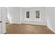 Well-lit bedroom with hardwood floors and two large windows at 5105 St George Ln, Hollywood, SC 29449