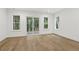 Bright bedroom with hardwood floors and access to a deck at 5105 St George Ln, Hollywood, SC 29449