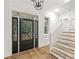 Entryway with hardwood floors, black door and staircase at 5105 St George Ln, Hollywood, SC 29449