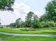 Landscaped golf course with a walking path near a tranquil waterway at 5105 St George Ln, Hollywood, SC 29449