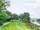 Golf course with a scenic view of a calm body of water at 5105 St George Ln, Hollywood, SC 29449