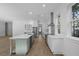 Modern kitchen with white cabinets, a large island, and stainless steel appliances at 5105 St George Ln, Hollywood, SC 29449