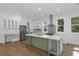 Modern kitchen with white cabinets, stainless steel appliances, and a light green island at 5105 St George Ln, Hollywood, SC 29449