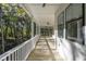 Relaxing covered porch overlooks a wooded backyard at 5105 St George Ln, Hollywood, SC 29449