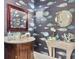 Stylish powder room with unique fish wallpaper and marble vanity at 6411 China Back Ln, Meggett, SC 29449