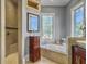 Bathroom boasts a large soaking tub, walk-in shower, and natural light at 6411 China Back Ln, Meggett, SC 29449