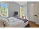 Bedroom with hardwood floors, large window and access to a balcony at 6411 China Back Ln, Meggett, SC 29449