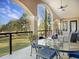 Covered patio with outdoor dining set and beautiful landscape views at 6411 China Back Ln, Meggett, SC 29449