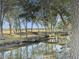 Serene waterfront view with wooden dock and lush trees at 6411 China Back Ln, Meggett, SC 29449