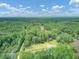 Aerial view of property showing home, pond, and expansive wooded area at 820 Pineneedle Way, Charleston, SC 29492