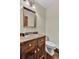 Small bathroom with wood vanity and oval toilet at 820 Pineneedle Way, Charleston, SC 29492