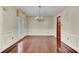 Bright dining room features hardwood floors and elegant chandelier at 820 Pineneedle Way, Charleston, SC 29492