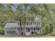 Two story house with wrap around porch, mature landscaping and trees at 820 Pineneedle Way, Charleston, SC 29492