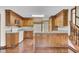 Kitchen with wood cabinets, island, and hardwood floors at 820 Pineneedle Way, Charleston, SC 29492