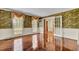 Spacious living room with hardwood floors and floral wallpaper at 820 Pineneedle Way, Charleston, SC 29492