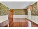 Bright living room with hardwood floors and floral wallpaper at 820 Pineneedle Way, Charleston, SC 29492