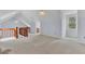 Spacious loft area with carpeted floor and wooden railing at 820 Pineneedle Way, Charleston, SC 29492