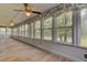Large screened porch with wood floors and window views at 820 Pineneedle Way, Charleston, SC 29492