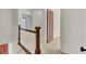 Upstairs hallway with wooden railing and carpet at 820 Pineneedle Way, Charleston, SC 29492
