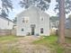 Two story home with fenced backyard, patio, and grass at 8781 Red Oak Dr, North Charleston, SC 29406