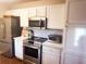 Kitchen with white cabinets, stainless steel appliances, and hardwood floors at 8781 Red Oak Dr, North Charleston, SC 29406