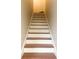 Staircase with white risers and dark wood treads at 8781 Red Oak Dr, North Charleston, SC 29406