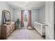 Charming Bedroom with crib, dresser, and natural light at 9159 Parlor Dr, Ladson, SC 29456