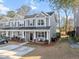 Two story townhome with gray siding, front porch, and driveway at 9159 Parlor Dr, Ladson, SC 29456