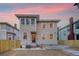 Two-story home with gray siding and a backyard patio at sunset at 929 Rutledge Ave, Charleston, SC 29403
