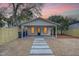 Detached studio with covered porch and stone walkway at dusk at 929 Rutledge Ave, Charleston, SC 29403