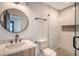 Stylish bathroom with a round mirror, light wood vanity, and a glass shower at 929 Rutledge Ave, Charleston, SC 29403