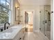 Bathroom with double vanity, walk-in shower, and access to bedroom at 929 Rutledge Ave, Charleston, SC 29403