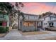 Two-story home with gray brick and light siding, a landscaped yard, and driveway at 929 Rutledge Ave, Charleston, SC 29403