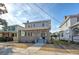 Two-story home with gray siding, brick base, and a front porch at 929 Rutledge Ave, Charleston, SC 29403